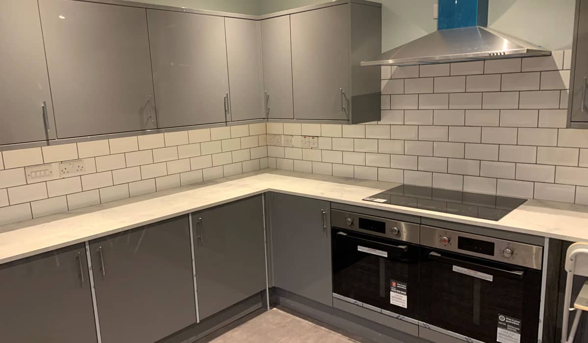 Grey kitchen with tiled splashbacks